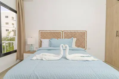 two swans towels on a bed in a bedroom at Chic Bayahibe 2BR in Sunshine near Bayahibe Center in Bayahibe