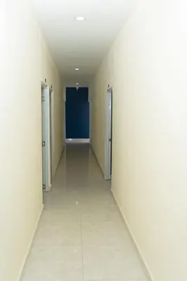 an empty hallway in a building with white walls at Hotel cotubanama