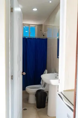 a bathroom with a toilet and a sink at Hotel cotubanama