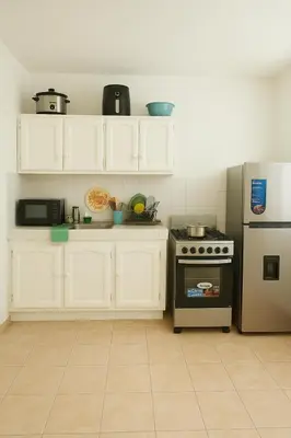a kitchen with white cabinets and a stove at One bedroom,central location Wifi&Ac in Cancino