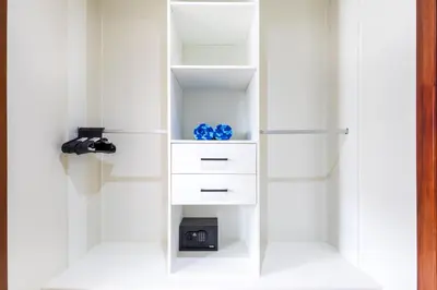 a white closet with white shelves and blue vases at 2BR Tropical Escape - Private Terrace, BBQ, Pool, Walk to Beach in Punta Cana