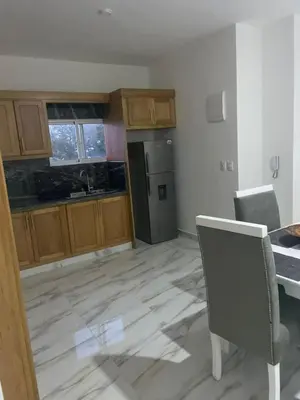 an empty kitchen with a table and chairs in it at res Montesino in San Felipe de Puerto Plata