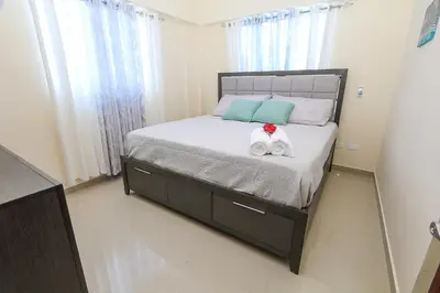 a bedroom with a bed with two stuffed animals on it at Edificio Amber in San Cristóbal