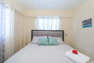 a bedroom with a large bed with two pillows at Edificio Amber in San Cristóbal