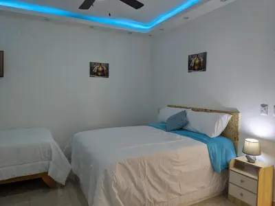 a bedroom with a bed and a blue ceiling at Azure Breeze Hotel in Bayahibe
