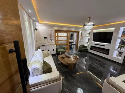 a living room with a white couch and a tv at private property just for you in San Isidro
