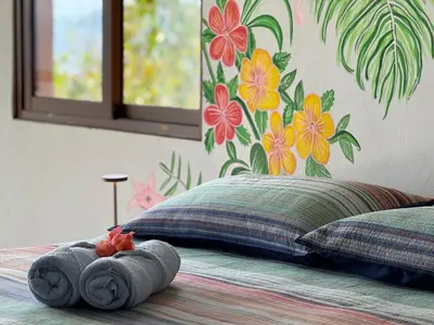 a bed with a stuffed animal on top of it at AguaSanta, Breeze & Views in Palmarito