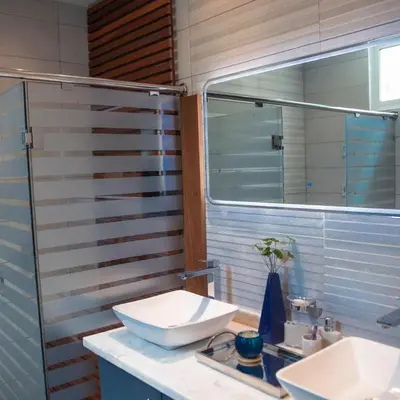 a bathroom with two sinks and a mirror at Crown 1 in Puerto Plata