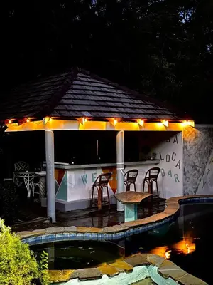 a gazebo with a table and chairs and lights at CasaLoca Cabarete Studio Apartment in Cabarete