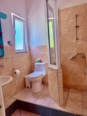 a bathroom with a toilet and a shower and a sink at CasaLoca Cabarete Studio Apartment in Cabarete