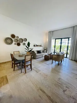 a large living room with a table and chairs at Stylish 1BR, Pools & Walk to Beach - Sublime in Las Terrenas