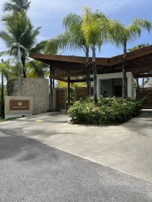 a building with palm trees in front of it at Stylish 1BR, Pools & Walk to Beach - Sublime in Las Terrenas