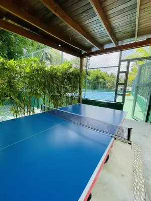 a blue ping pong table in a tennis court at Stylish 1BR, Pools & Walk to Beach - Sublime in Las Terrenas