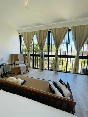 a large living room with a couch and windows at 2BR Getaway Villa in Montecristi in San Fernando de Monte Cristi