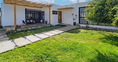 a backyard of a house with a grass yard at 2BR Getaway Villa in Montecristi in San Fernando de Monte Cristi