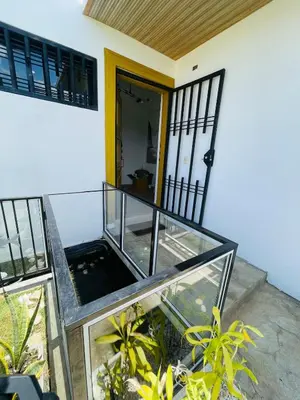 a glass house with a balcony with plants at 2BR Getaway Villa in Montecristi in San Fernando de Monte Cristi