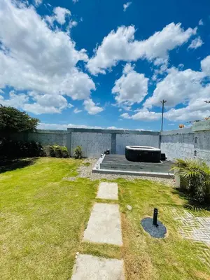 a backyard with a concrete wall and grass at 2BR Getaway Villa in Montecristi in San Fernando de Monte Cristi
