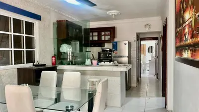 a kitchen with a glass table and white chairs at Sea Near and Beach a few minutes walking Top Location by RHV Living in San Felipe de Puerto Plata