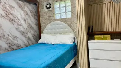a bedroom with a bed with a white headboard at Sea Near and Beach a few minutes walking Top Location by RHV Living in San Felipe de Puerto Plata
