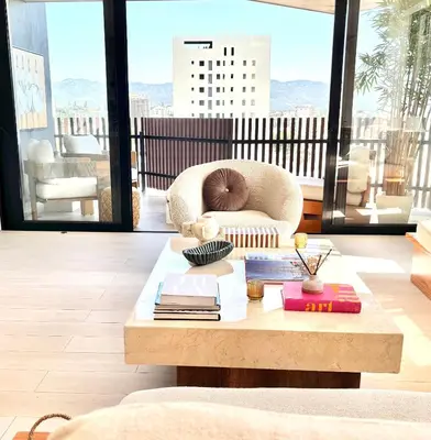 a living room with a coffee table and a chair at Casita Coco - Luxury Apartment in Santiago in Santiago de los Caballeros