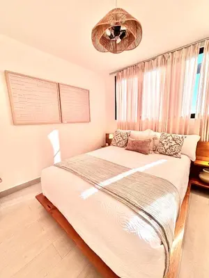 a bedroom with a large bed and a window at Casita Coco - Luxury Apartment in Santiago in Santiago de los Caballeros