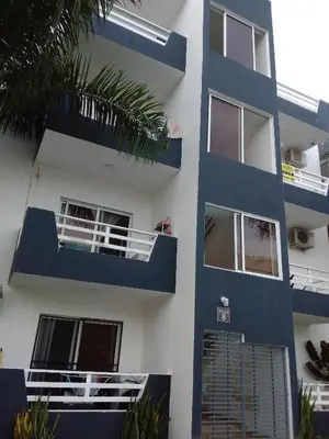 a blue and white apartment building with a balcony at Villa del mar in Bayahibe