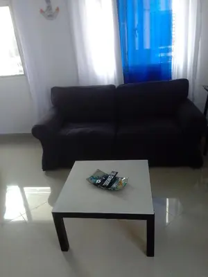 a living room with a black couch and a coffee table at Villa del mar in Bayahibe