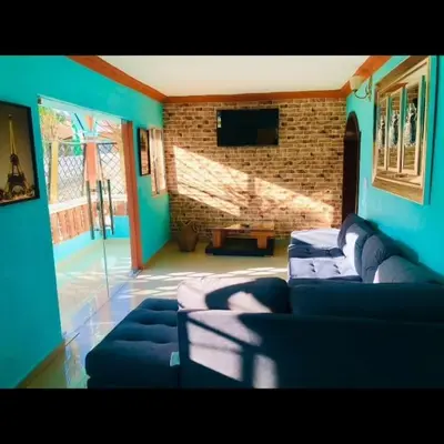 a living room with blue walls and a couch at Doña Nida Family Hotel in Santa Cruz de Barahona