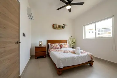 a bedroom with a bed and a ceiling fan at Armonía Las Terrenas in Las Terrenas