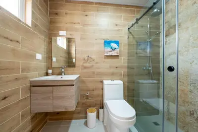 a bathroom with a toilet and a sink and a shower at Armonía Las Terrenas in Las Terrenas