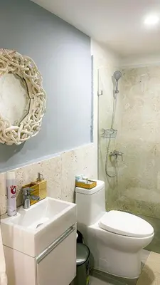 a bathroom with a toilet and a sink and a shower at Modern, Comfortable, Close to Beaches in Colorado