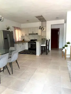 a kitchen with a table and chairs in a room at Hermosa villa familiar in Colorado