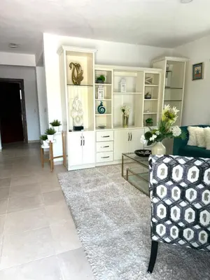 a living room with white cabinets and a couch at Hermosa villa familiar in Colorado