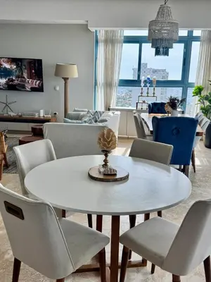 a living room with a white table and chairs at Juan dolio Penthouse, beach access 3BR Salitre Tower front of Club Hemingway in Juan Dolio