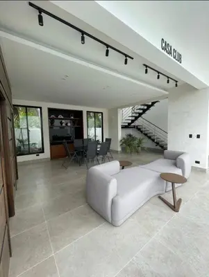 a living room with a white couch and a table at Residenza in Santiago de los Caballeros