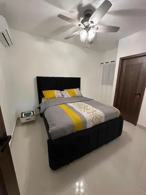 a bedroom with a bed with a ceiling fan at Residenza in Santiago de los Caballeros