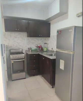 a kitchen with a stainless steel refrigerator and a sink at Habitación con baño privado y otras áreas compartidas in San Luis