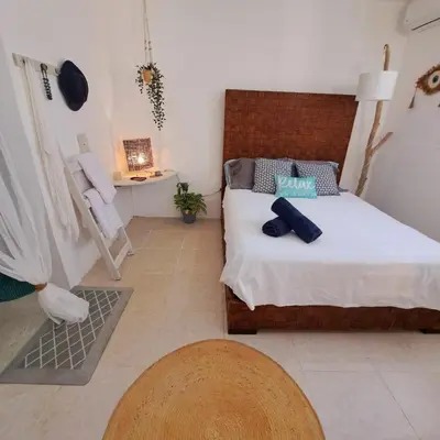 a small bedroom with a bed and a table at Beach Bungalow 100 m Playa Coson in Las Terrenas