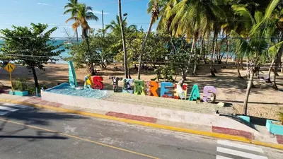 a sign that says surfboards on the side of a street at Beach Bungalow 100 m Playa Coson in Las Terrenas