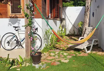 a bike parked next to a house with flowers at Beach Bungalow 100 m Playa Coson in Las Terrenas