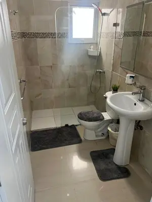 a bathroom with a toilet and a sink at Paisible et confo in Boca Chica