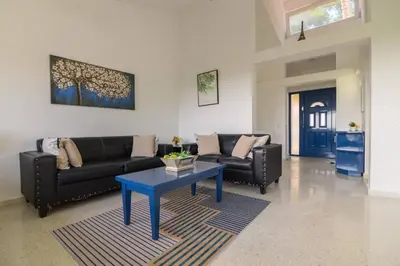 a living room with two couches and a blue table at Casa Jobo Scenic ViewsPrivate Pool TablePool in San Felipe de Puerto Plata