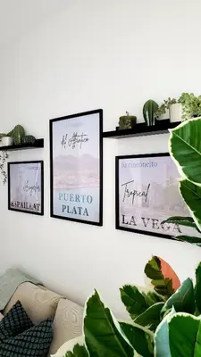 three framed pictures on a wall with plants at Backup Power 2BR 2BA AC WiFi Gym 24h Security Ideal for long stays in Santiago de los Caballeros