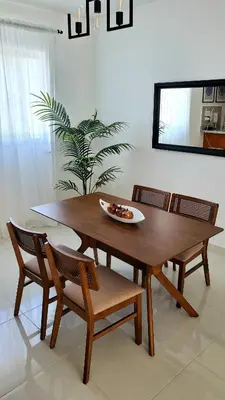 a wooden table and chairs in a living room at Backup Power 2BR 2BA AC WiFi Gym 24h Security Ideal for long stays in Santiago de los Caballeros