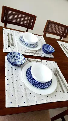 a table with blue and white plates and utensils at Backup Power 2BR 2BA AC WiFi Gym 24h Security Ideal for long stays in Santiago de los Caballeros