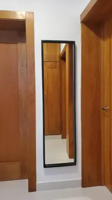 a mirror on a wall next to a door at Backup Power 2BR 2BA AC WiFi Gym 24h Security Ideal for long stays in Santiago de los Caballeros