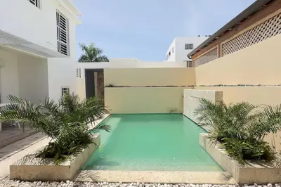 a swimming pool in front of a house at Elegante Casa Estrella Marina 117 Pool BBQ in La Romana