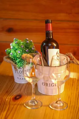 a bottle of wine and two glasses on a table at Villa Dulce Refugio in Cabrera