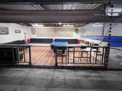 a room with a ping pong table and chairs at Villa las Terrazas in Cabayona