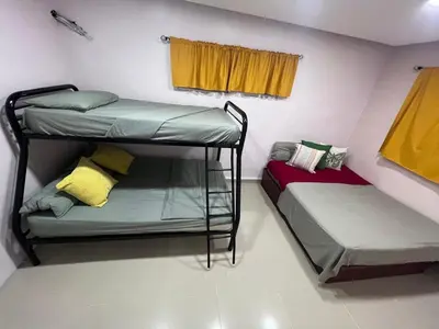 two bunk beds in a room with a window at Villa las Terrazas in Cabayona